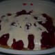 The first layer with strawberry pie filling and cream mixture.