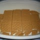 Graham Crackers lined at the bottom of a dessert bowl.