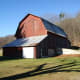the traditional gambrel roof shape served a practical purpose. It increased the space for storing hay in the hay loft.