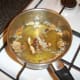 Porcini mushrooms and onion added to chicken stock