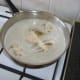 Chicken strips are fried in a deep frying pan
