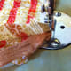 Keep the ribbon in between while sewing and fold it at some places to give a round shape