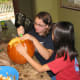 Carving Pumpkins. Team work in pumpkin carving makes it more fun. Have a couple of pumpkins for kids to work on together. Let them make designs on paper before marking the pumpkin to carve.