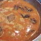 Adding the fried fish pieces in the mustard masala gravy