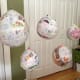 Hang paper mache planets to dry. Protect the floor with newspaper or an old bed sheet.