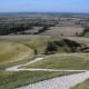 Closeup shot of a few chalk lines of the Uffington White Horse. Dragon Hill on the background.