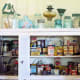 A shelf or cabinet with glass pane is the perfect place to display vintage containers, cans, tupperware and more!