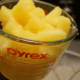 Add the pineapple chunks to a large pitcher or serving bowl.