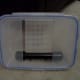 Face plate (lid) attached to scrubber with scrubber screen mounted inside