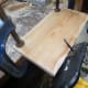 hewing pine floorboards to make shelving