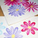 Two pieces of foam board with the flowers that I practiced making.