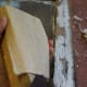 After scraping, sand the remaining paint smooth. Use a block of wood to rest the sandpaper on, to make it easier to sand.