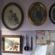 Picture painted by Gertrude Burgess (Baglin) under painting of her with her dog Sam, other old family photos framed and next to her hearing aid and letter opener.