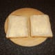 Bread slices are lightly buttered on one side only