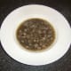 Tongue, green lentil and red onion soup is plated