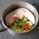 Vegetables and seasonings are added to the pot
