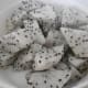 White fleshed dragon fruit with irregularly scattered tiny black seeds