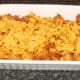 Grated cheese is scattered over spicy beef and pasta
