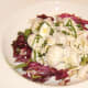 Chicken and conchiglie salad is garnished with basil