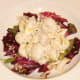 Chicken and conchiglie salad is spooned on to leafy bed