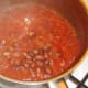 Borlotti beans are added to beef and tomato pasta sauce