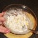 Folding the chicken and pasta through the mayo and sweetcorn