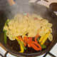 Conchiglie pasta is drained and added to bell peppers