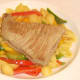 Tuna steak is carefully laid on top of conchiglie and bell peppers