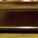 The hinge is hidden on the back of the tea chest.