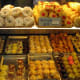 An enticing display of luscious pasties and cookies inside a typical bakery.