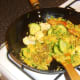 Vegetables are stirred in to spiced duck and rice