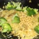 Broccoli and chickpeas are added to duck leg biryani