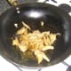 Stir frying steamed duck leg meat in biryani spices
