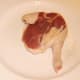 Duck leg is seasoned before it is roasted