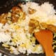 Cooled rice is added to spiced duck meat
