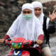 An Indonesian woman in Banda Aceh, wearing her doa guan.