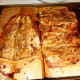 When ready, let fish sit for 5" on plank, and then using a butter knife separate meat from the skin and remove bones if not previously deboned.