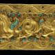 A first century sleeve decorated with a scene of animals in combat, measuring 23.5 x 9cm, from a tomb in Tillia Tepe, Afghanistan, provided by The Afghanistan National Museum, is pictured at the 'Afghanistan, Rediscovered Treasures' exhibition at Mus