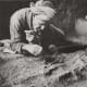 Excavations from Tillya Tepe, Tomb IV, Second quarter of the 1st century AD. An Afghan archaeologist carefully uncovers the golden dagger from Tomb IV, 1978 - © Viktor Sarianidi, National Museum of Afghanistan / Musée Guimet