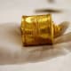 French restorers examine a small gold vessel with Greek inscriptions from the first century, discovered in 1978 on the archeological site of Tillia Tepe (north Afghanistan) and exposed for the 'Afghanistan, Rediscovered Treasures' exhibition at Musee