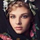 This girl is wearing a "vinok" and a "hustka", which is a traditional embroidered shawl or scarf that usually has fringes