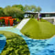 Raised area in children’s area with rock wall on one side & wide slide on other side