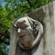 Sculpted faces with park chronology under it.