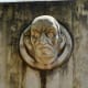 Sculpted faces with park chronology under it.