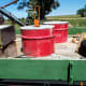 Here are the barrels ready to be moved from a truck bed and lowered into prepared trenches.
