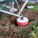 Angle iron guides, which will be used to anchor the hopper feet, are used as the bin is tilted into place.