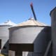 Using a lifting ring, the operator lifts the bin up so that one ring at a time may be dismantled . . .