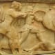 Siphnian Treasury, close-up of Apollo (short tunic) and his twin sister Artemis (longer gown) taking on the Giants.