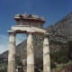 The Tholos, built around 380 BCE, is made of fine Pentelic marble and dark limestone from Eleusis, and many visitors mistake it for Athena's temple. It was originally a circular building, and it's quite a puzzle-- circular shrines like this were norm