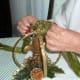 Step 3: Time to tie a length of ribbon at top joint of mobile. Thread ribbon under top joint of mobile tie tightly at outer top of top joint. This ribbon will be needed to hang suspend your mobile, from where you decide to hang it.